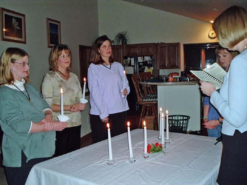 Marla and fellow new inductees, holding candles, take the oath as new members of the Beta Sigma Phi sorority, Kappa Theta Chapter of the Roaring Fork valley.