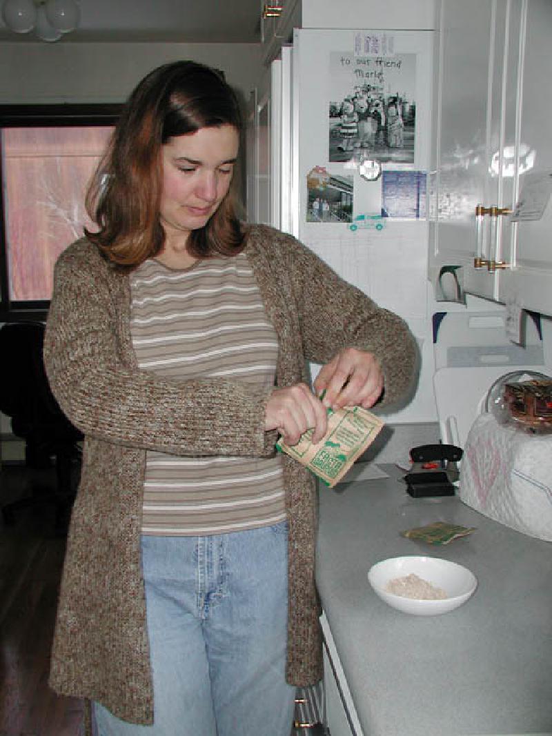 Continuing to improve her ability to use her right hand in daily activities, Marla uses it while opening a package of instant oatmeal for breakfast!