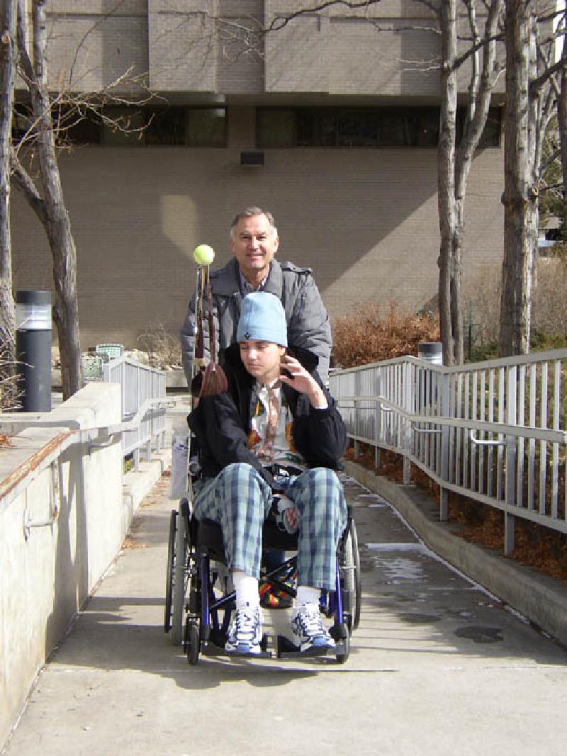 Marla waving while enjoying some fresh air outside on a walk with Dad, Leo.