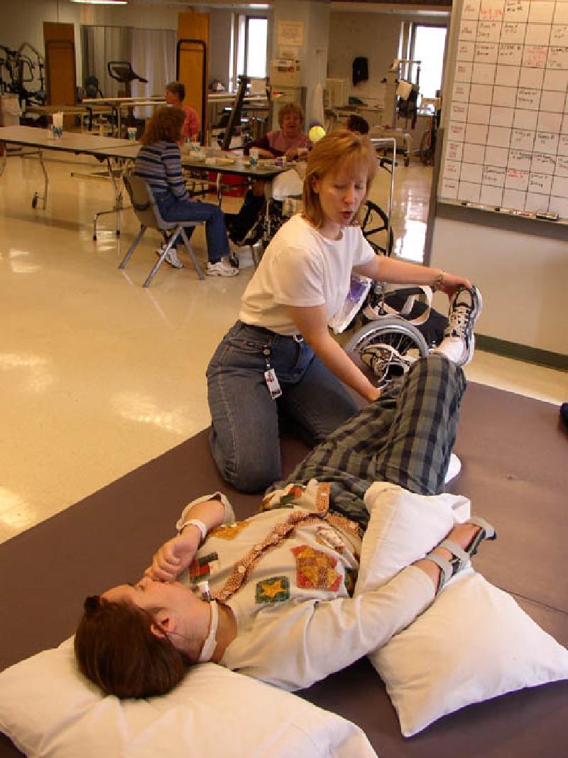 Marla working with Jean Milholland, one of her physical therapists, on the mat in the PT gym during afternoon class.