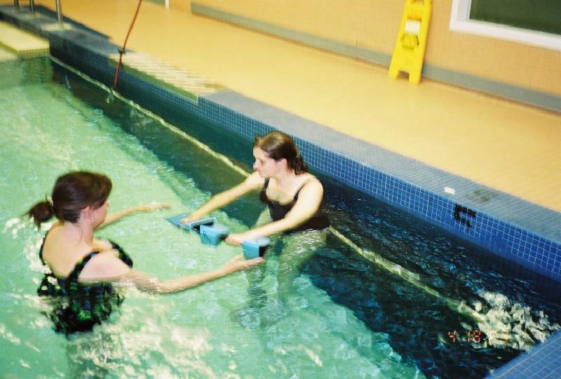 Lisa works Marla with the water weights for added resistance.