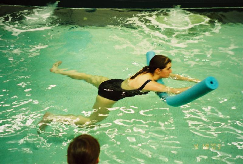 Getting some kicking exercise on the legs while using a water noodle for upper body support.