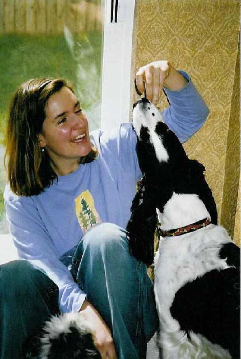 Daisy eagerly accepts a treat from Marla, while Rosie "patiently" waits.