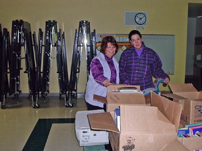 Debbie McKenna, family friend, and a counselor at Sopris Elementary School in Glenwood Springs, assists while Marla sorts through the vast array of teaching materials she had put together during her career teaching elementary school. Although it was hard for Marla to let go, she decided it was time that these hard-earned childrens books, art supplies, and learning materials, again benefit as many students as possible. Towards this end, she donated these materials by holding an open house for teachers at Sopris Elementary, welcoming them to use them as they see fit.