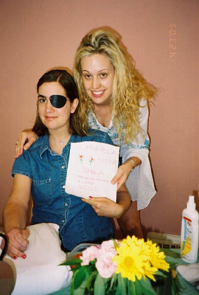 Marla and Nicole show off a picture they drew together.