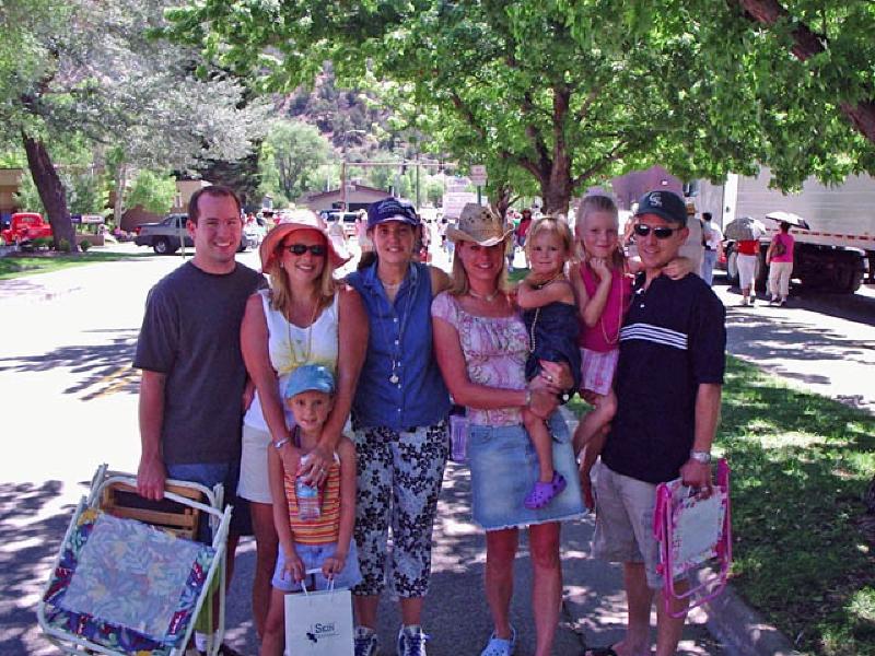High school friends Shea Rawe, and Jennifer Cianfrance with their families at the Strawberry Days parade.