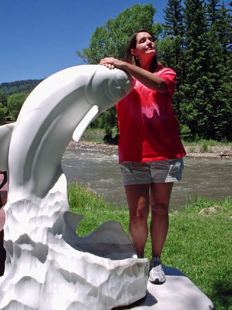 Marla poses next to a trout sculpted from the dazzling white marble during an outing to Redstone, south of Glenwood Springs.