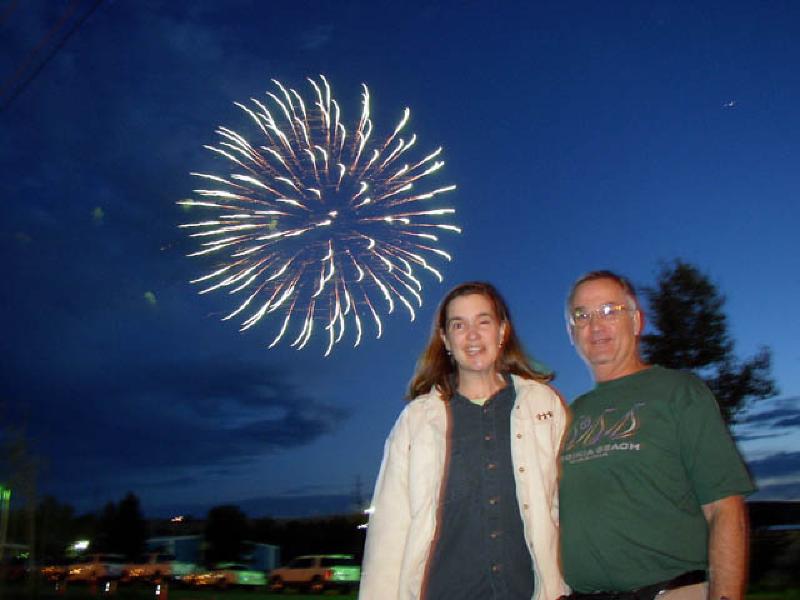 A firework lights the sky behind Marla and Leo while watching the display in Montrose.