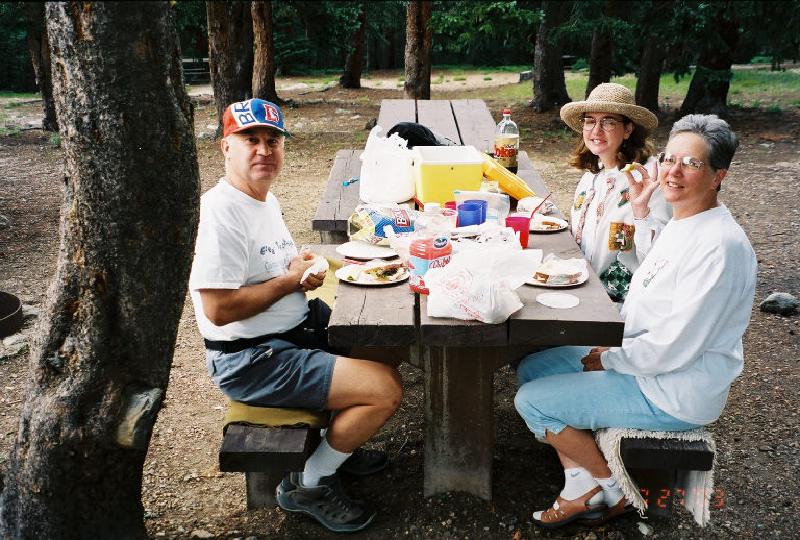 Mary, Marla and Leo enjoy the fresh mountain air as they have a picnic lunch together.