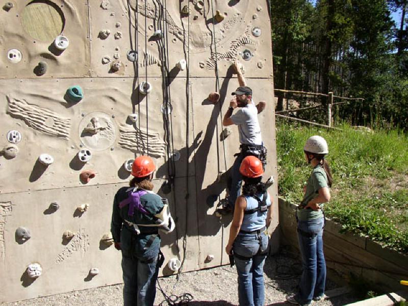 BOEC instructor Eric Marchese offers Marla and Vikki a few tips on getting up the wall.