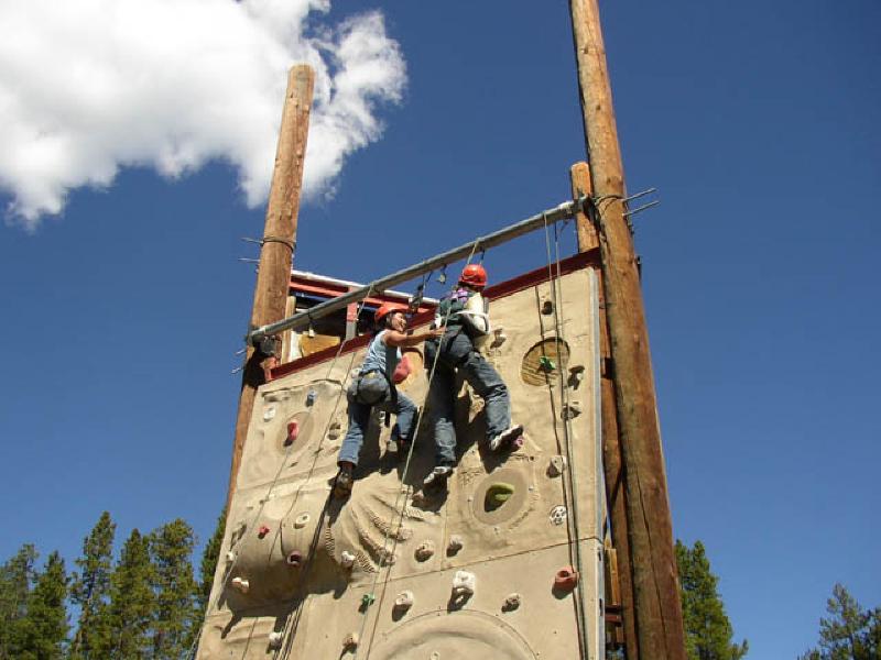 Marla rings the bell at the top of the wall, as she reaches her goal at the top!She is attaining new heights in her recovery.