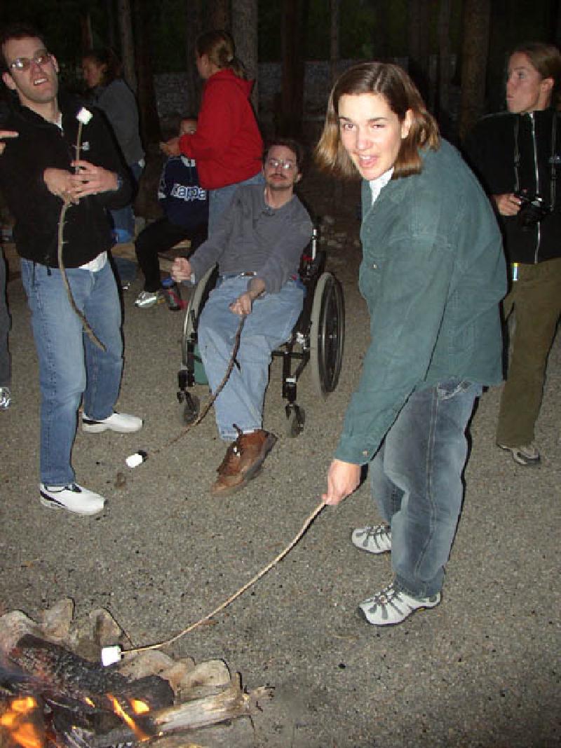 Adam, Sean and Marla are roasting their marshmallows to make s'mores.