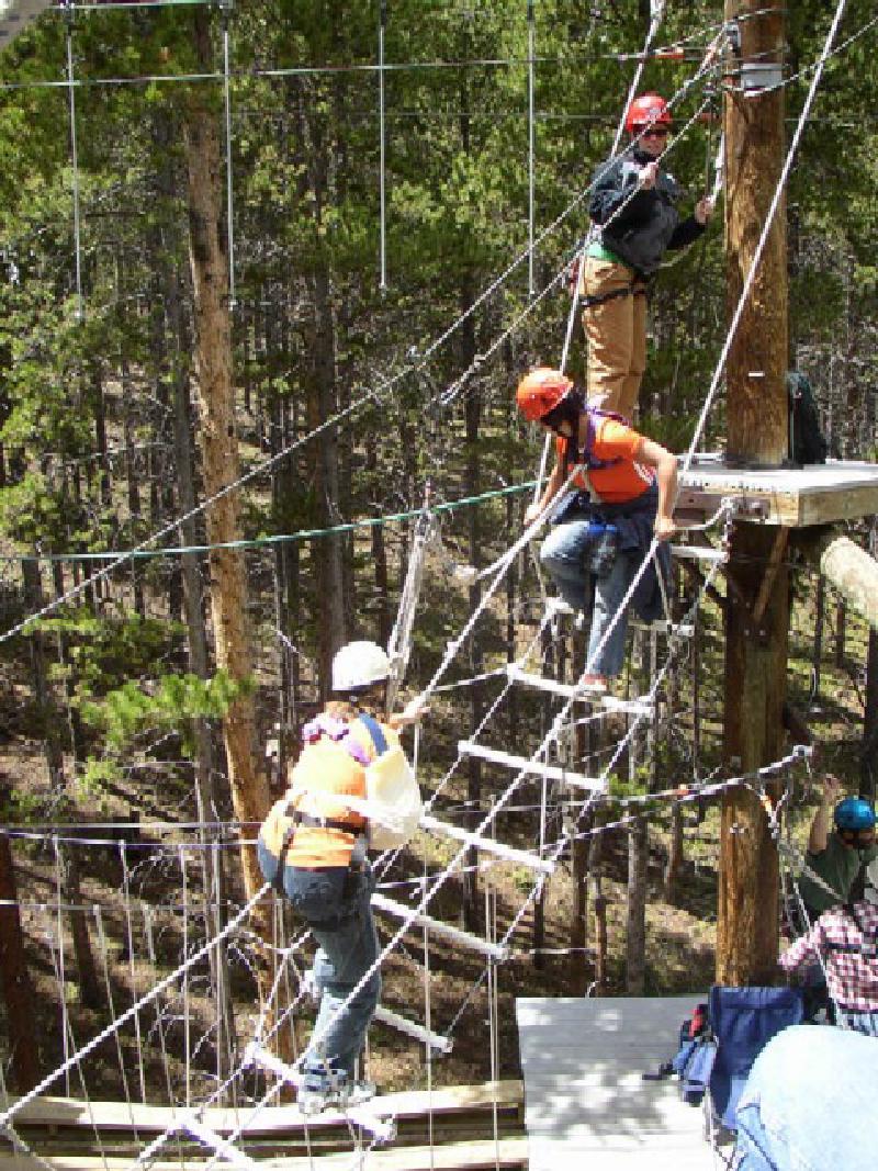 Working her way through the obstacles, Marla climbs the rope ladder.
