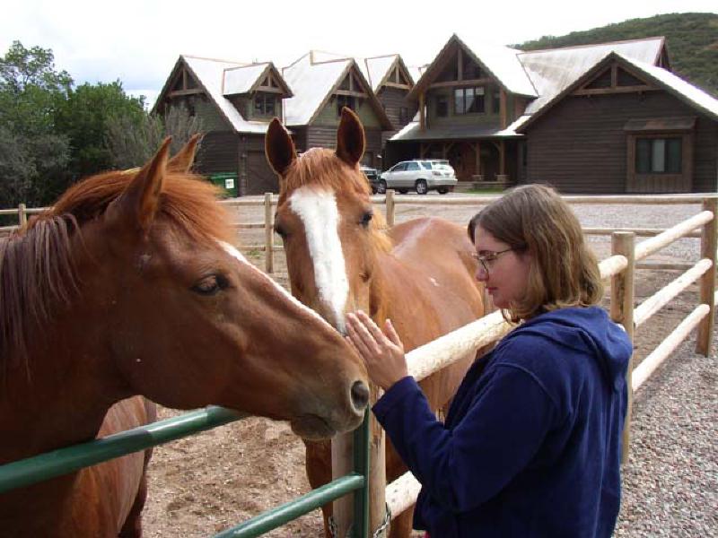 Marla enjoys petting the horses during a visit to the home of her cousin Brad, and Brad's wife Patty.
