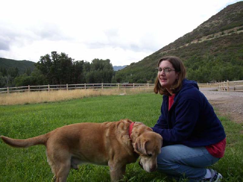 Marla laughs while playing with Brad's golden lab, Barney.