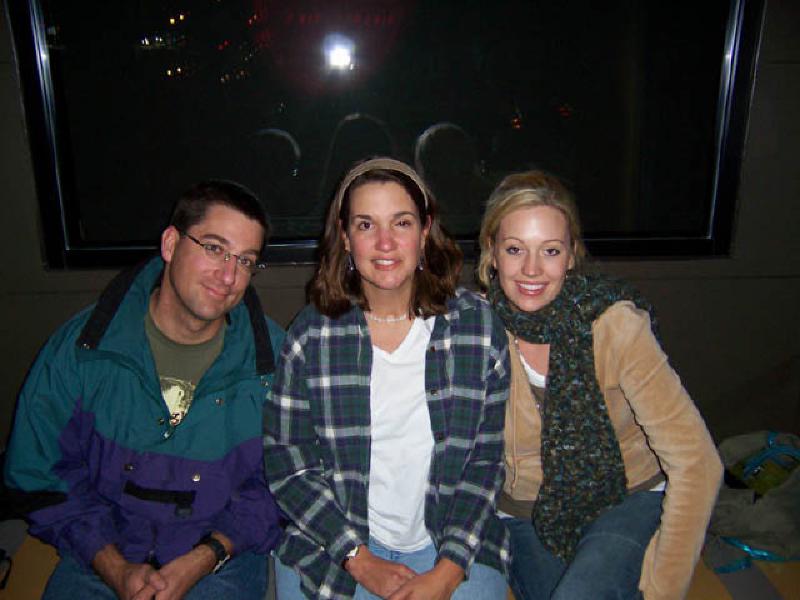 Cousins Mark, Marla, and Nicole converse and catch up while waiting for a table at dinner in Nashville.