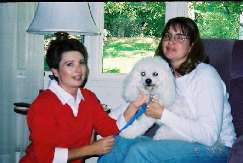 Marla gets some snuggles from Melody's other Bichon, Montgomery.