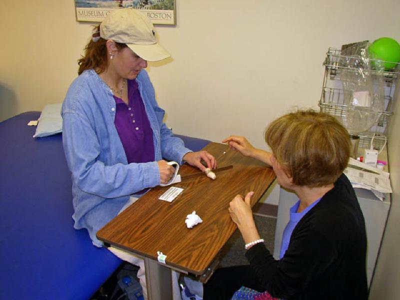 Marla made some amazing strides in her occupational therapy at the University of Michigan academic hospital. Here, she's using a specially adapted knife allowing her to cut with her right hand and arm.