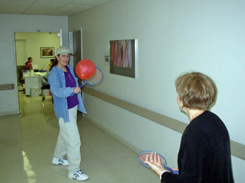 Marla's OT works with her on eye hand coordination by playing "hall tennis" with a balloon, improving Marla's reflexes with her right arm.