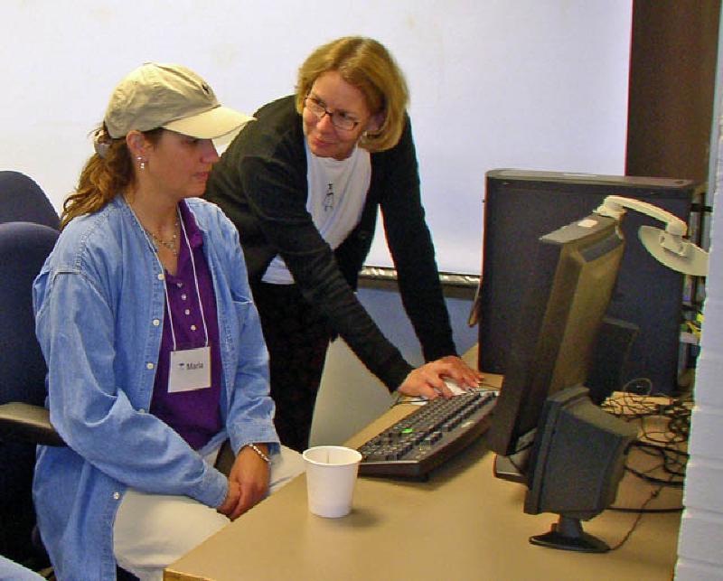 Melodie, another of Marla's therapists, explains the particulars of one of the speech programs to her.