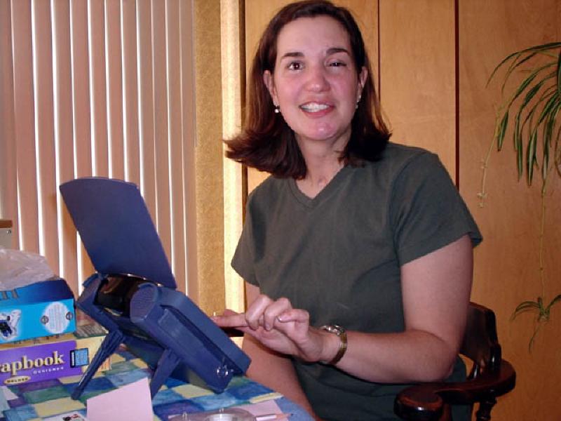 Marla experiments with her new Dynavox computer. The touch screen has menus for many common words used in daily conversation and communication, and uses a speech synthesizer to pronounce them. The computer helps Marla with word recall and also practice!