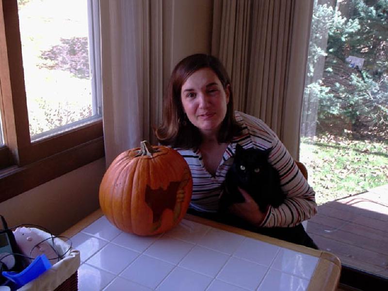 Puck, the perfect Halloween black cat, poses next to the jack-o-lantern for which he modeled as Marla carved!