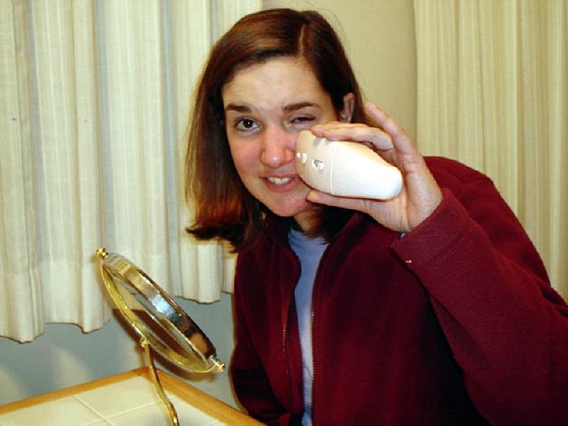 Marla works with the facial electrical stimulation device that she is using to help recover function in the nerves and muscles on the left side of her face.