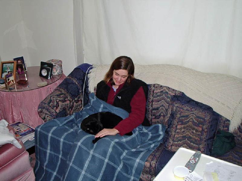 Puck, always up for a warm lap, snuggles with Marla to beat the cold.