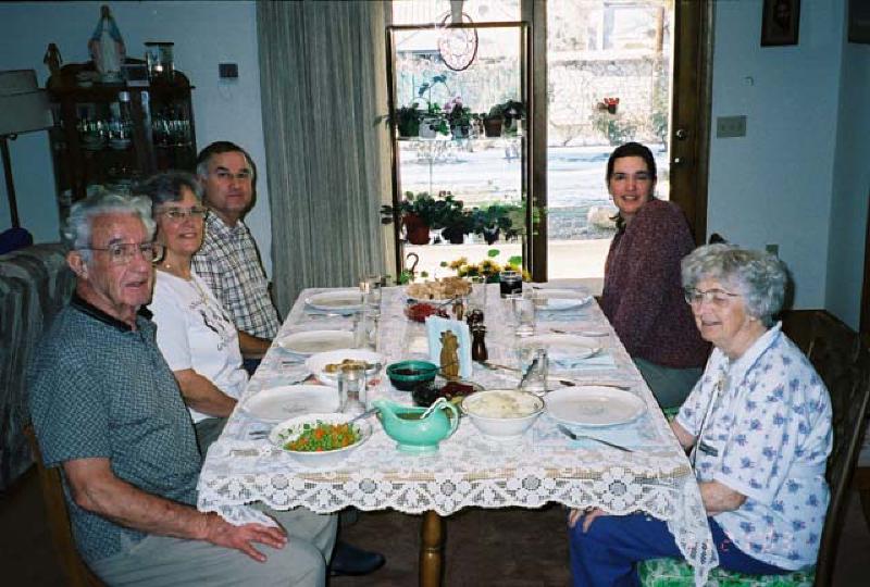 The family sits down to enjoy Thanksgiving Dinner at the home of Marla's grandparents, Howard and Mary, in Montrose, Colorado.