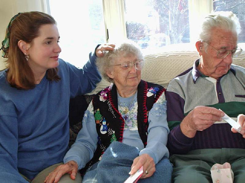 Marla watches as Grandparents Mary and Howard Williams open a present or two.