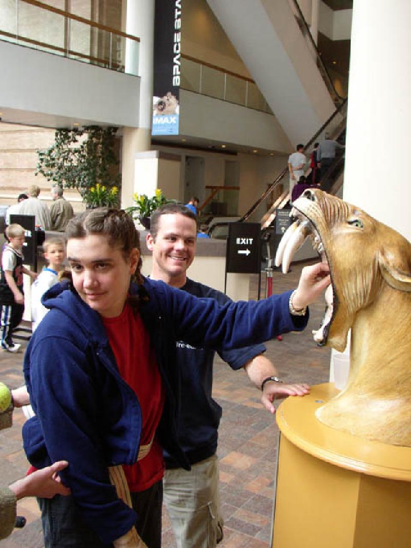 Marla feeds a quarter to the sabre-tooth tiger, which has accepted donations from visitors ever since she visited as a youngster.