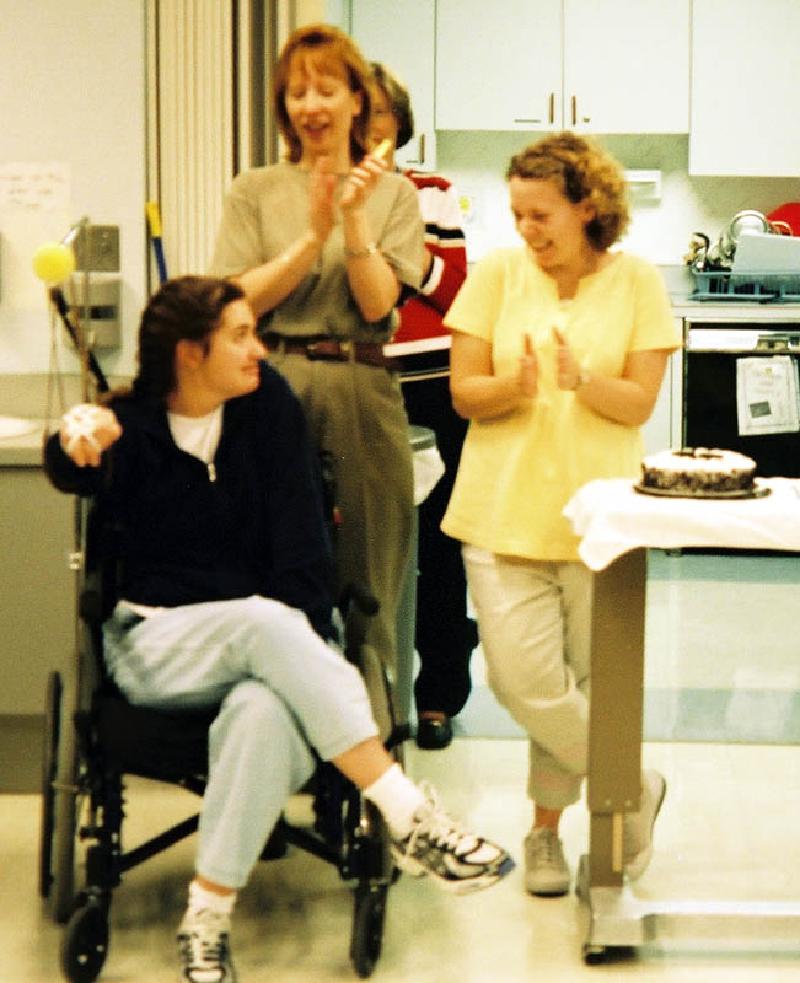 Marla receives a well-deserved round of applause from therapists Jean Milholland and Peggy Fausett, and the rest of the graduates!